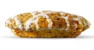 Close-up of a sweet Lemon Poppy Seed Muffin, a popular bakery item from the 7 Brew menu.