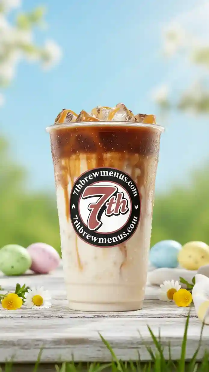 Clear cup of a refreshing iced Caramel Macchiato specialty drink from the 7 Brew menu.